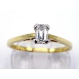 An 18 carat gold and single stone diamond ring, the baguette cut approx. 0.25 carat, shank fully