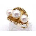 A cultured pearl ring, set with three slightly graduated pearls (the largest 7.3mm), mounted on a