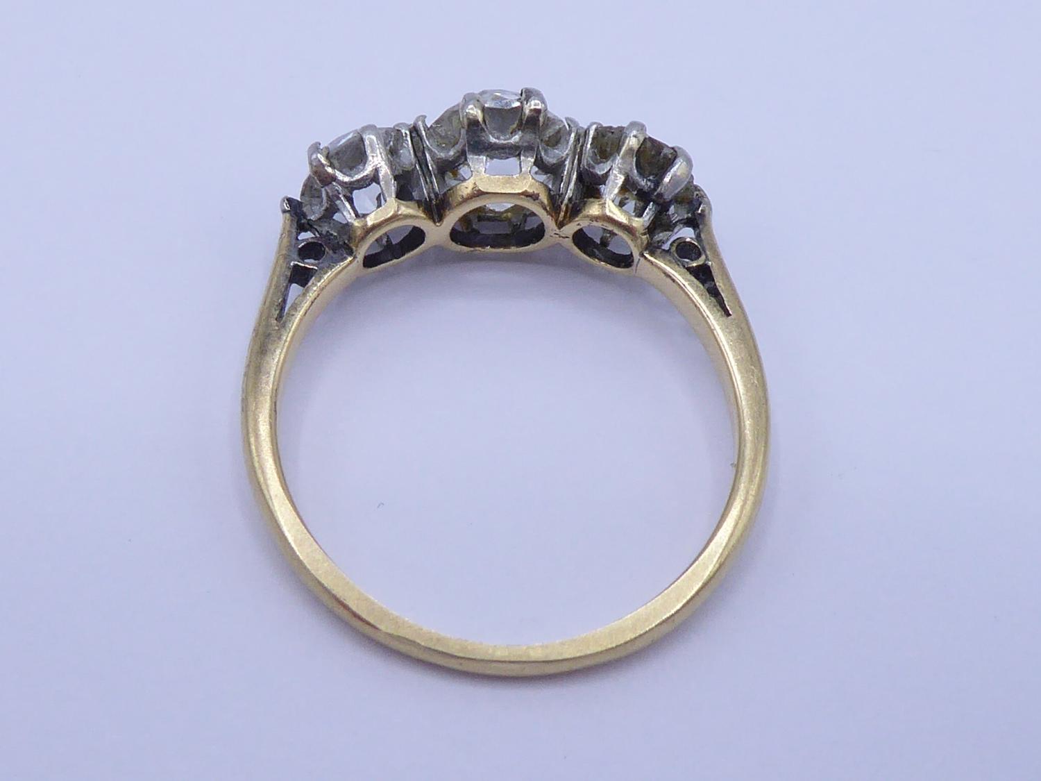 A three stone diamond ring, the central old mine cut approx. 0.75 carat, flanked by two old - Image 2 of 2