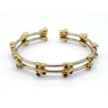 An Italian 18 carat gold and gem set bangles, set aound its length with butterflies, each with wings