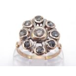 A diamond cluster ring, the central brilliant approx. 0.10 carat, in a starburst surround of rose