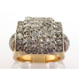 A French Art Deco diamond ring, the stepped square bezel pave set overall with small, uniform double