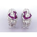 A pair of diamond and ruby ear clips, each with a calibre cut heart and banner motif to the