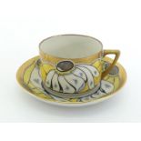 A Russian porcelain cup and saucer by the Dulevo factory in 1925, the design alternating yellow