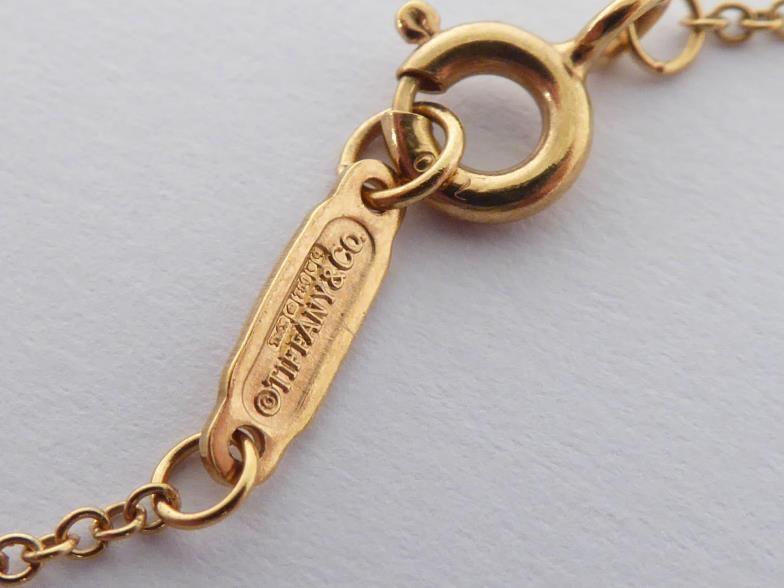 TIFFANY & Co., an 18 carat gold key pendant, signed and hallmarked, 4.5cm long, together with 18 - Image 2 of 5