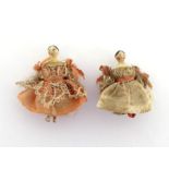 A pair of very small miniature painted dolls with articulated limbs, dressed in ball gowns. 3cm.