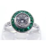 A diamond and emerald target cluster ring, the central old brilliant cut approx. 0.44 carat, in a