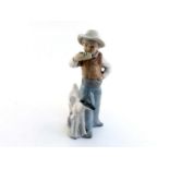 A ceramic group of a boy with his goats and playing pipes. Stamp to underside "Tenora, Hand made