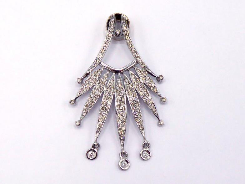 A diamond pendant, of spray design, pave set overall with small brilliants, three spectacle set