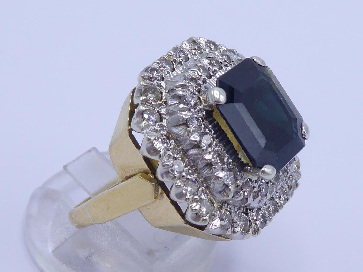 A sapphire and diamond cluster ring, the central step cut sapphire 11 x 10mm, claw set above a - Image 4 of 4