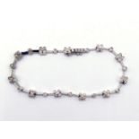 A diamond line bracelet, composed of alternate five stone clusters of brilliants and single