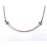 TIFFANY, 'Smile', an 18 carat white gold pendant necklace, the chain tagged, signed and