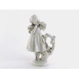 A 19th. century German blanc de chine figure of a young girl in dress with puffed sleeves trimmed