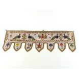 An Indian beadwork portal hanging with large lappets, the whole decorated with peacocks, animals,