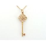 TIFFANY & Co., an 18 carat gold key pendant, signed and hallmarked, 4.5cm long, together with 18