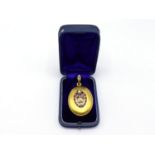 A 19th century Austro-Hungarian gold, ruby, diamond and pearl locket, the oval body of matt gold,