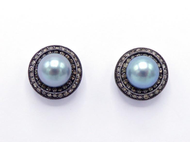 A pair of cultured pearl and diamond ear studs, the grey pearls 8.6mm, in a two row surround of