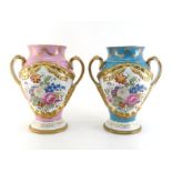 A matched pair of very large two handled ceramic vases, one blue, one pink, each with panels of hand