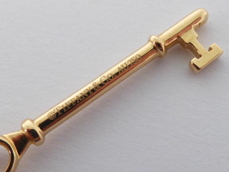 TIFFANY & Co., an 18 carat gold key pendant, signed and hallmarked, 4.5cm long, together with 18 - Image 3 of 5