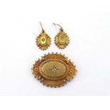 A Victorian 15 carat gold and diamond brooch and earring suite, the shaped oval brooch with