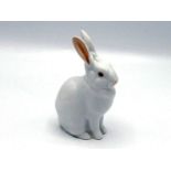 A ceramic seated white rabbit by Herend, with raised ears lined in pink, pink eyes and nose, the