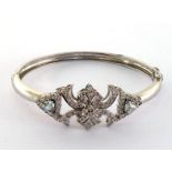 A diamond and aquamarine bangle, the front scrollwork motif pave set overall with brilliants,