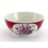 A Russian ceramic bowl by Gardner, decorated in the traditional manner with white panels of anemones