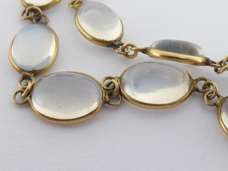 A moonstone necklace, composed of graduated oval cabochons, each spectacle set, to a bolt ring - Image 3 of 3