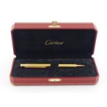 CARTIER, Must de Cartier, a gold plated ballpoint pen, with its box, in working condition