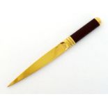 Asprey. A gold-plated stiletto paper knife with leather handle in original box, the blade marked "