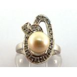 A cultured pearl and diamond dress ring, the central pearl 8.4mm in a pave set brilliant cut