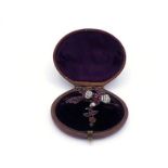 A 19th century garnet and seed pearl brooch, modelled as bird with sprig, pave set over the wing