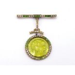 An early 20th century demantoid garnet, seed pearl and tourmaline pendant brooch, the carved