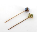 Two Victorian gold and gem set stick pins, the first set about the spherical head with rub over