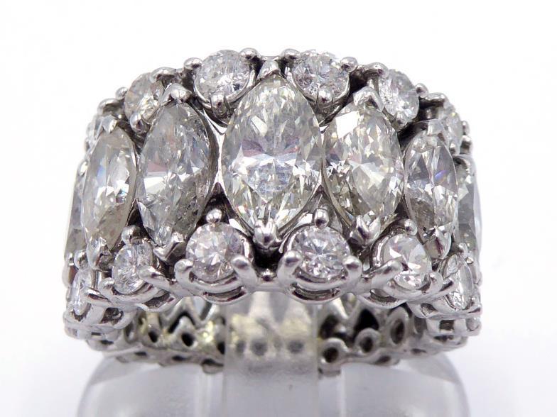 A diamond ring, the central row claw set with graduated marquise cuts totalling approx. 5.91 carats,