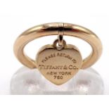 TIFFANY & Co., an 18 carat rose gold ring, suspended with a signed heart tag, finger size J, 5.