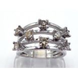 A diamond dress ring, composed of four bars separated with eight claw set brilliants totalling