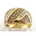 An 18 carat gold and diamond band ring, the wide band set with calibre cut chevron design, pave