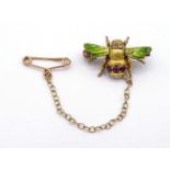 A Victorian ruby, diamond and enamel brooch, modelled as a bee, the body set with rose cut diamonds,