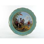 A ceramic display plate showing two cavalrymen in 17th century costume approaching an encampment,