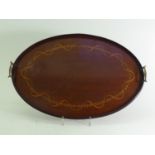 A George III oval mahogany tray with gallery and brass handles, inlaid with a continuous laurel