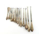 Thirteen silver-handled button hooks and a similar shoe horn, various dates and makers and of