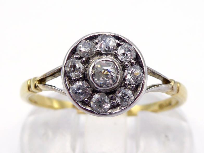 An early 20th century diamond cluster ring, composed of a central old mine cut in a surround of