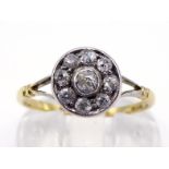 An early 20th century diamond cluster ring, composed of a central old mine cut in a surround of