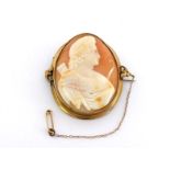 A 19th century shell cameo brooch, the large oval cameo depicting a youthful Cupid in profile,