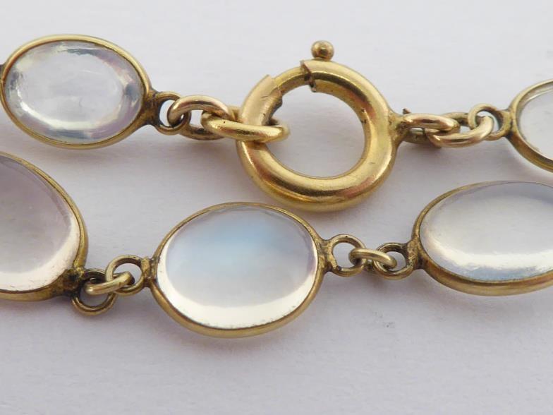 A moonstone necklace, composed of graduated oval cabochons, each spectacle set, to a bolt ring - Image 2 of 3