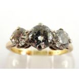 A three stone diamond ring, the central transition cut brilliant approx. 0.50 carat, flanked by