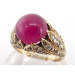 A mid 20th century synthetic ruby and diamond ring, the cabochon ruby 9.7mm, above a flame