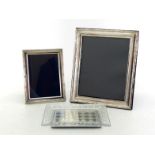 Two modern silver-fronted photograph frames with reed and tie decoration, 21.6 cm. high,