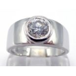 A single stone diamond ring, the brilliant cut approx. 1 carat, in a rub over mount, the white metal